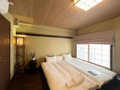a bedroom with a large white bed with a window at Remon House Asakusa Tokyo in Tokyo