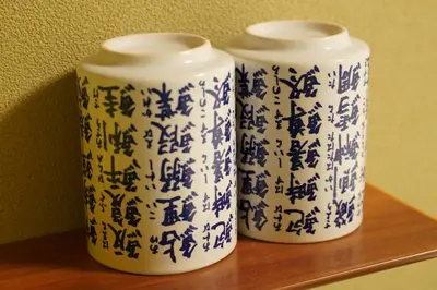 two blue and white vases sitting on a shelf at Remon House Asakusa Tokyo in Tokyo