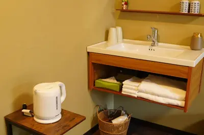 a bathroom with a sink and a counter with towels at Remon House Asakusa Tokyo in Tokyo