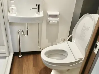 a bathroom with a white toilet and a sink at Remon House Asakusa Tokyo in Tokyo