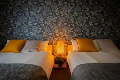 two beds sitting next to each other in a bedroom at -Asakusa 5chome- 12-minute walk to Asakusa Station! in Tokyo