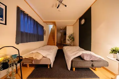 a room with two beds and a staircase with a window at -Asakusa 5chome- 12-minute walk to Asakusa Station! in Tokyo