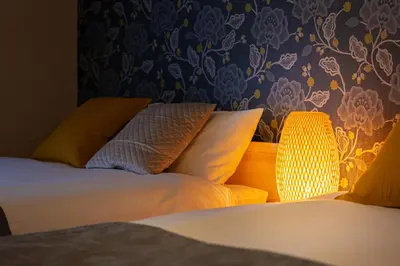 a bedroom with a bed with pillows and a lamp at -Asakusa 5chome- 12-minute walk to Asakusa Station! in Tokyo