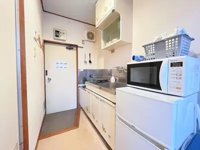 a kitchen with a microwave and a sink at Yamato Heights YH22 in Tokyo