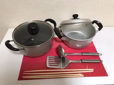 a pot and utensils sitting on a red napkin at Yamato Heights YH22 in Tokyo