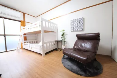 a living room with a chair and a bunk bed at Yamato Heights YH27 in Tokyo