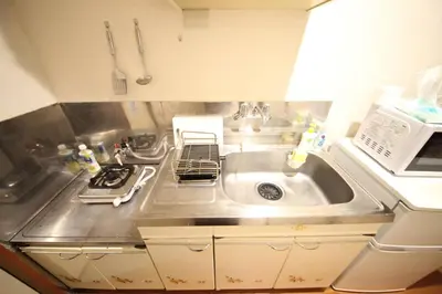 a kitchen with a sink and a microwave at Yamato Heights YH27 in Tokyo