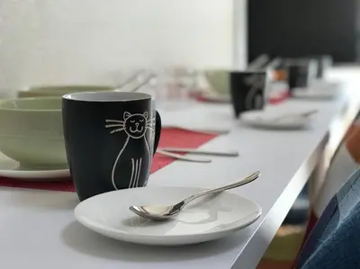 a table with a plate and a coffee cup and a spoon at Yamato Heights YH27 in Tokyo
