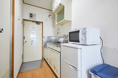 a kitchen with a microwave on top of a refrigerator at Yamato Heights YH27 in Tokyo