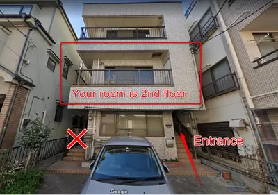 a car parked in a parking lot in front of a building at Nishigokencho NA2 in Tokyo