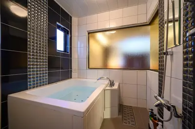 a bathroom with a tub and a window at \u30db\u30c6\u30eb\u30db\u30ef\u30a4\u30c8\u30b7\u30c6\u30a323Adults only in Tokyo