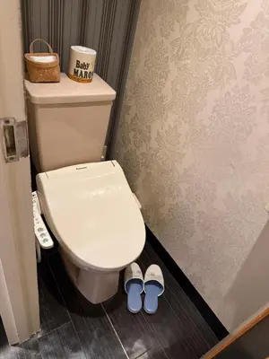 a bathroom with a toilet and two pairs of shoes at \u30db\u30c6\u30eb\u30db\u30ef\u30a4\u30c8\u30b7\u30c6\u30a323Adults only in Tokyo