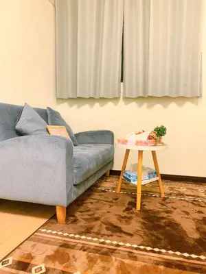 a living room with a blue couch and a table at Shinjuku Suginami in Tokyo