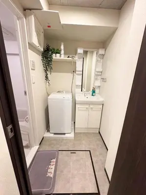 a small kitchen with a refrigerator and a sink at FL Residence Kagura Futei II in Tokyo