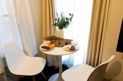 a small table with two white chairs and food on it at FL Residence Kagura Futei II in Tokyo