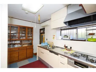 a kitchen with white counters and wooden cabinets at Tokyo Gu - Vacation STAY 18156 in Tokyo