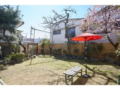 a red umbrella and a bench in a yard at Tokyo Gu - Vacation STAY 18156 in Tokyo