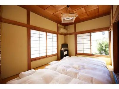 a large white bed in a room with windows at Tokyo Gu - Vacation STAY 18156 in Tokyo
