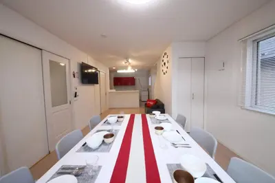 a dining room with a red and white table and chairs at Urayasu Detached house UK1 in Tokyo