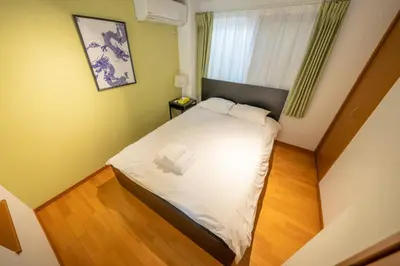 a small bedroom with a bed in a room at XS14 XROSS STAY Higashi shinjuku1 \u6771\u65b0\u5bbf in Tokyo