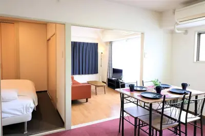 a room with a table and a room with a bed at Cosmy-2 IC53 in Tokyo