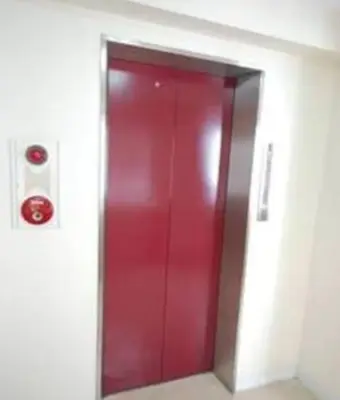 a red elevator door in a building with a red button at Cosmy-2 IC53 in Tokyo