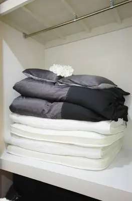 a stack of pillows sitting on a shelf at Cosmy-2 IC53 in Tokyo