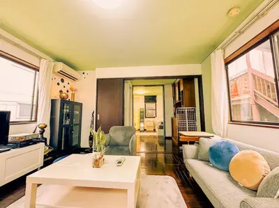 a living room with a couch and a table at Shibuya area large Home 10m walking to Shibuya Stream Building in Tokyo