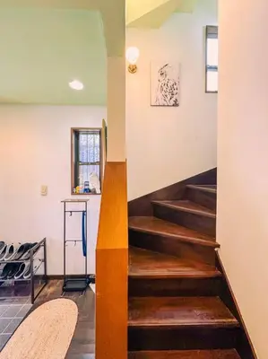 a staircase with wooden steps in a room at Shibuya area large Home 10m walking to Shibuya Stream Building in Tokyo