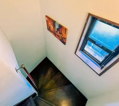 a staircase with a window in a stair case at Shibuya area large Home 10m walking to Shibuya Stream Building in Tokyo