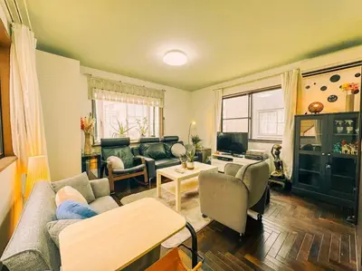 a living room with a couch and a table at Shibuya area large Home 10m walking to Shibuya Stream Building in Tokyo
