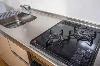 a stove top with two burners on it next to a sink at Kinshicho detached house KK23 in Tokyo