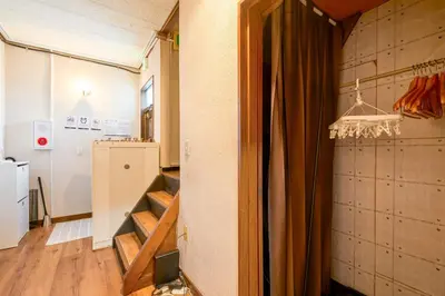 a room with a staircase and a refrigerator at Kinshicho detached house KK23 in Tokyo