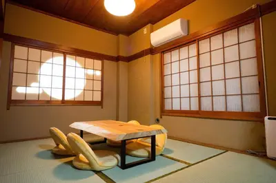 a room with a table and chairs in it at Kinshicho detached house KK23 in Tokyo