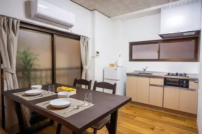 a kitchen with a table and a dining room at Kinshicho detached house KK23 in Tokyo