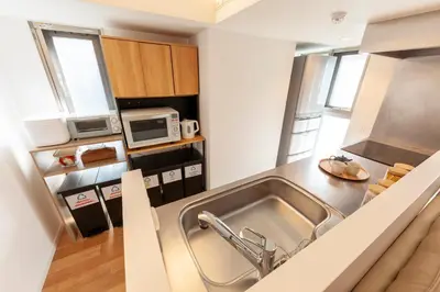 a kitchen with a sink and a microwave at Premier suite Roppongi Tokyo in Tokyo