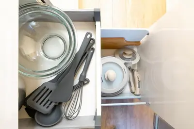 a kitchen cabinet with utensils and a sink at Premier suite Roppongi Tokyo in Tokyo