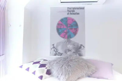 a magazine with a picture of a woman on a bed at Marine Cove Hatsudai by Tranova in Tokyo