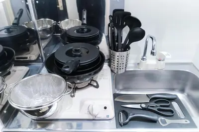 a kitchen sink with dishes and utensils in it at Marine Cove Hatsudai by Tranova in Tokyo