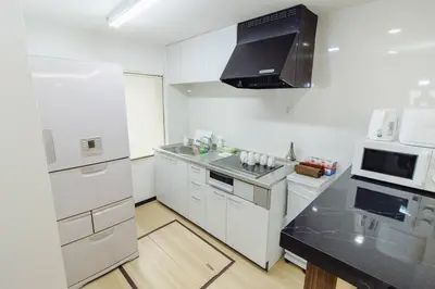 a kitchen with white appliances and a black counter top at QiQi House Tokyo Hirai Villa 2Bath3WCs 4min Station 24min to Akihabara in Tokyo