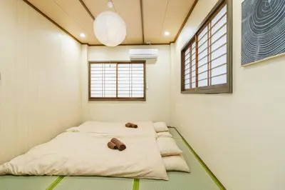 a room with four beds in it with windows at QiQi House Tokyo Hirai Villa 2Bath3WCs 4min Station 24min to Akihabara in Tokyo