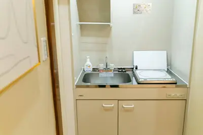 a kitchen with a sink and a laptop on a counter at QiQi House Tokyo Hirai Villa 2Bath3WCs 4min Station 24min to Akihabara in Tokyo