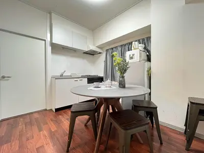 a small kitchen with a table and chairs in a room at Tobu High Line Daimon 201 TH1 in Tokyo