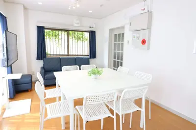 a kitchen and dining room with a white table and chairs at Senkawa CV House SC1 in Tokyo