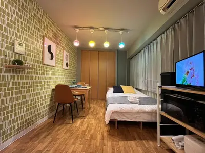 a bedroom with a bed and a table and a television at SW Nishi Waseda 202 SN22 in Tokyo