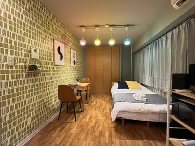 a bedroom with a bed and a table and chairs at SW Nishi Waseda 202 SN22 in Tokyo