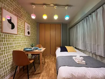 a bedroom with two beds and a desk and a table at SW Nishi Waseda 202 SN22 in Tokyo