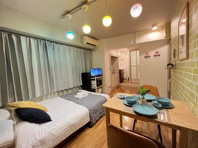 a bedroom with a bed and a table with a dining room at SW Nishi Waseda 202 SN22 in Tokyo