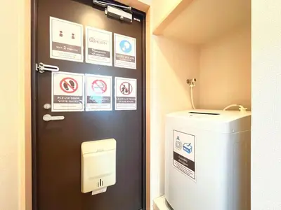 a bathroom with a door with signs on it at Belle Vie Waseda BW32 in Tokyo