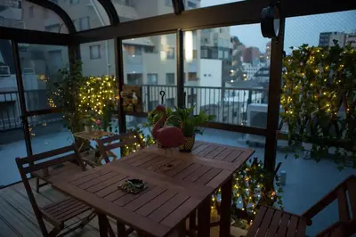 a table on a balcony with a pink bird on it at SY-HOTEL Kuramae 5mins \u673a\u573a\u76f4\u8fbe \u4ea4\u901a\u4fbf\u5229 \u8535\u524d5\u5206\u949f in Tokyo